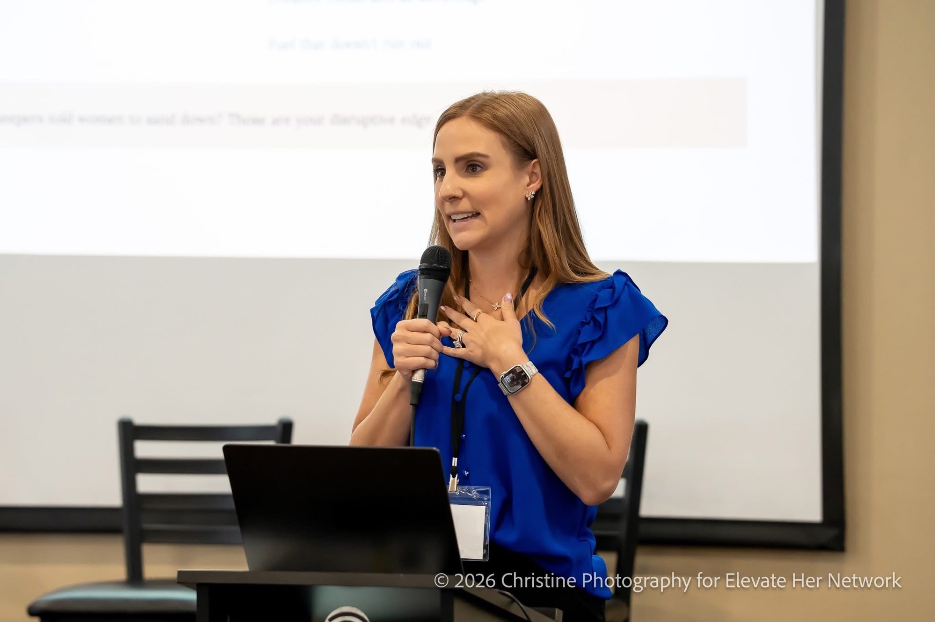 Erin Pash speaking into a microphone